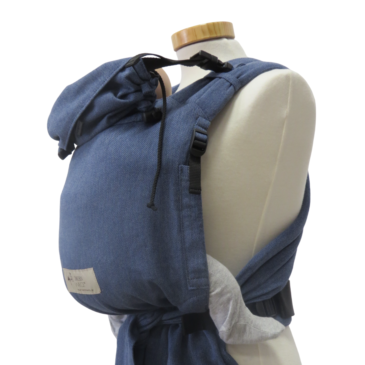 Babycarrier with jeans design and adjustable straps on mannequin.