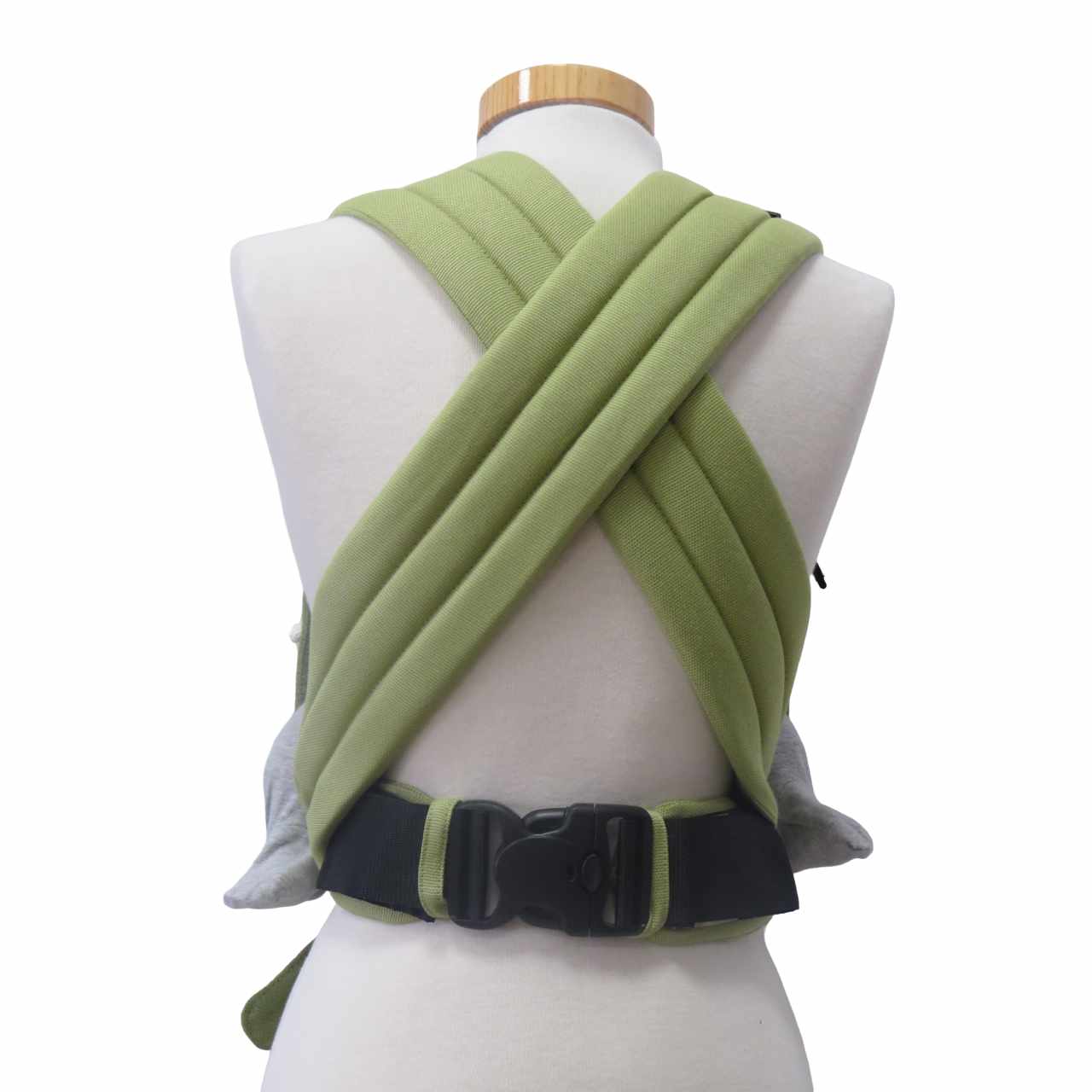 Green adjustable half-buckle baby carrier with web pattern, padded straps, and three-point safety buckle.