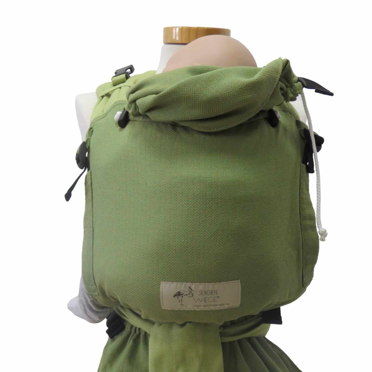 Green Babycarrier Leo Grün with adjustable half-buckle design, web pattern pouch, and padded straps.