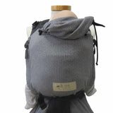 Black and white Babycarrier Leo with adjustable half-buckle, soft webbed design, padded straps, and infant head support.