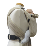 Babytrage Natur Half-Buckle in beige with newborn, adjustable cushioned straps.