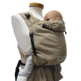 Babycarrier Sand in use, showing adjustable straps and ergonomic design for newborns to toddlers.