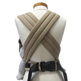Babycarrier Sand with adjustable straps and safety buckle in sand color.