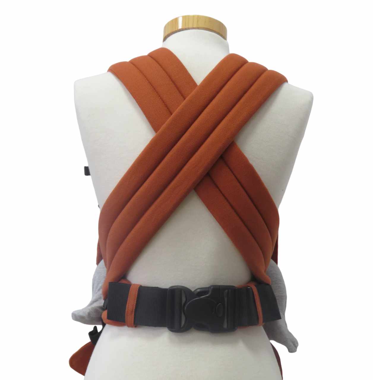 BabyCarrier Terra in orange with padded straps and buckle.