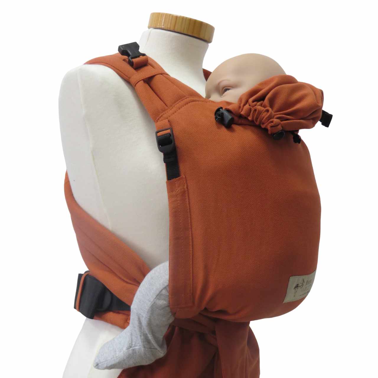 BabyCarrier Terra with adjustable straps and safety buckle, shown with baby in front-carry position.