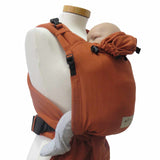 BabyCarrier Terra with adjustable straps and safety buckle, shown with baby in front-carry position.