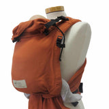BabyCarrier Terra half-buckle in orange cotton fabric on mannequin.