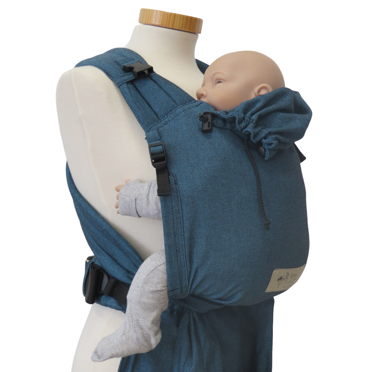 Babycarrier Türkis with adjustable straps and safety buckle.