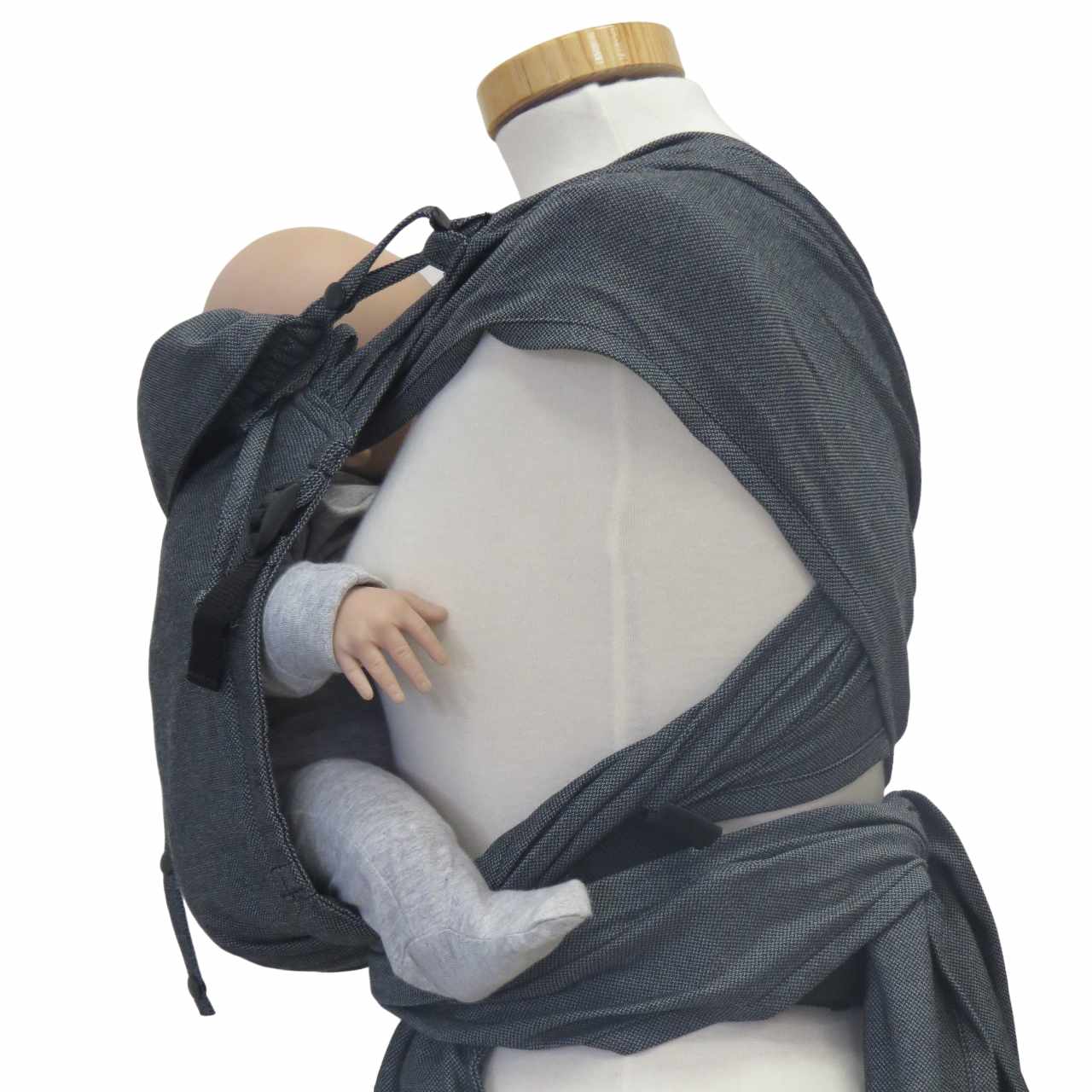 Wrapbabycarrier Graphit with wide shoulder straps and hip belt, shown in use carrying a baby.