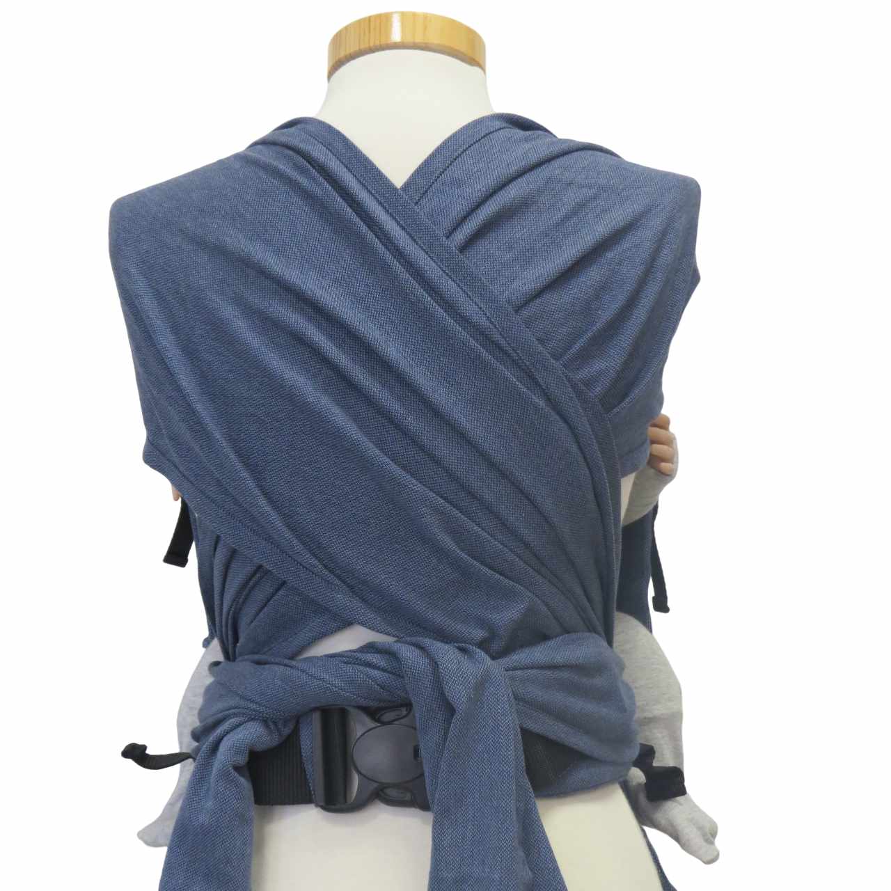 Jeans-optic wrap baby carrier with wide shoulder straps and secure waist belt.