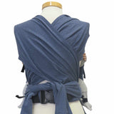 Jeans-optic wrap baby carrier with wide shoulder straps and secure waist belt.