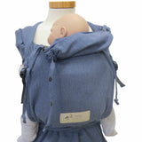Denim-style wrap baby carrier with broad shoulder straps and hip belt.