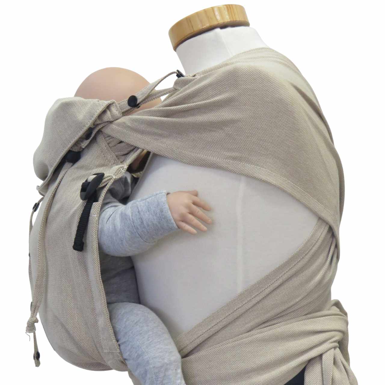 Natural color wrap baby carrier with wide shoulder straps and buckle hip belt for optimal comfort and support.