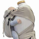 Natural color wrap baby carrier with wide shoulder straps and buckle hip belt for optimal comfort and support.