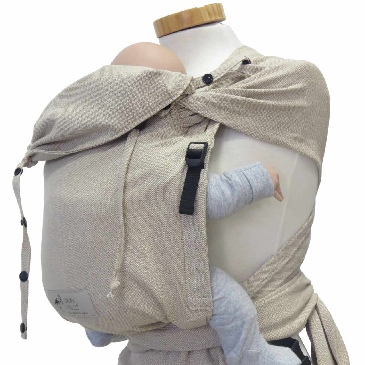 Wrapbabycarrier Natur in beige with broad shoulder straps and adjustable hip belt for carrying infants safely and comfortably.