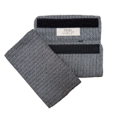 Babycarrier Gurtschoner in black and white pattern, 100% cotton, featuring Velcro attachment for shoulder straps.