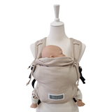 Valeno Mondstein baby carrier with full buckle, padded straps, chest strap, adjustable seat, and integrated head support in beige cotton