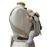 Babycarrier Natur Slim with adjustable half-buckle design in natural color, featuring padded straps and waistband.