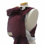 Babytrage Babycarrier Bordeaux with padded straps and ergonomic design on a mannequin.