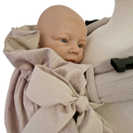 Storchenwiege Tragecover Natur covering baby for warmth and protection.
