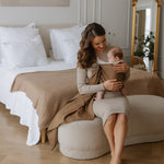 Ringsling Leo Cafe with delicate weave pattern in use for carrying a baby indoors.