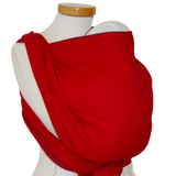 Red baby wrap with subtle woven pattern, made from 100% OEKO-TEX certified cotton, suitable from birth to toddler, easy binding with color-coded edges.
