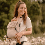 Adaptable natural Babycarrier, half-buckle design, 100% cotton, supports 3.5-15 kg, padded straps and waistband.