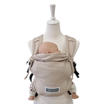 Valeno Mondstein baby carrier with full buckle, padded straps, chest strap, adjustable seat, and integrated head support in beige cotton