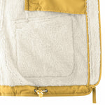 Interior view of Mamalila Allwetter Tragejacke showing warm teddy fleece lining and mustard yellow outer fabric
