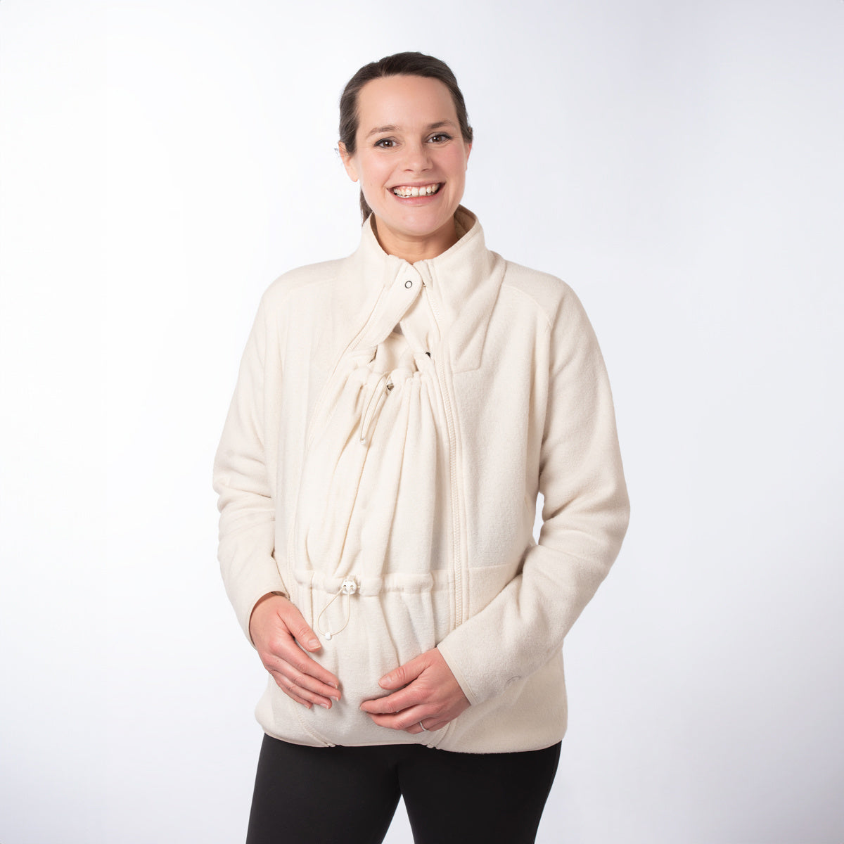Woman wearing cream Mamalila Fleece Tragejacke babywearing jacket with breathable micro-sherpa fleece and adjustable neck protection